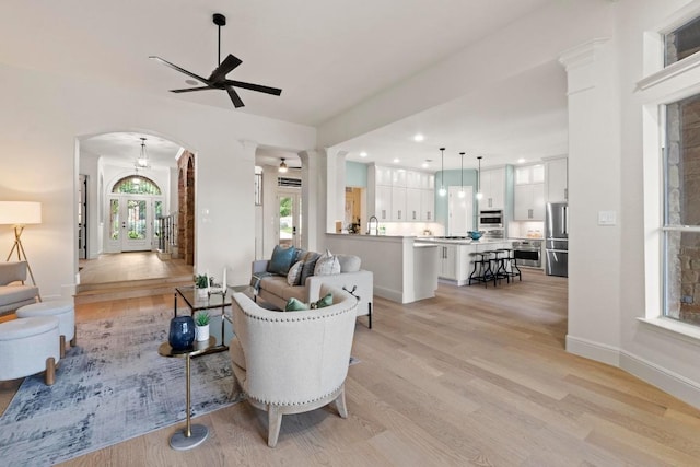 908 Lakewood Hills Ter, Austin, TX 78732 - living room with arched walkways, light wood-style floors, ceiling fan, and recessed lighting