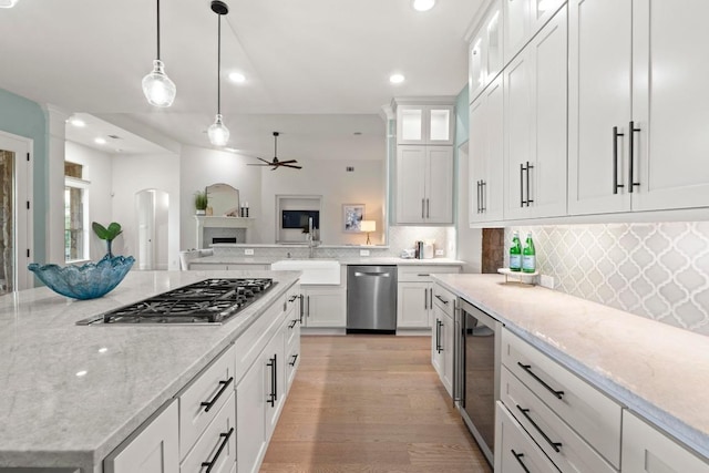 908 Lakewood Hills Ter, Austin, TX 78732 - kitchen featuring stainless steel appliances, wine cooler, open floor plan, recessed lighting, and backsplash