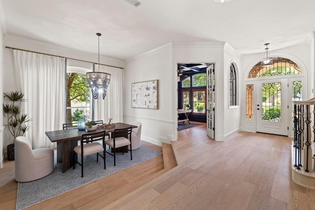 908 Lakewood Hills Ter, Austin, TX 78732 - entrance foyer with light wood-type flooring, a chandelier, and crown molding