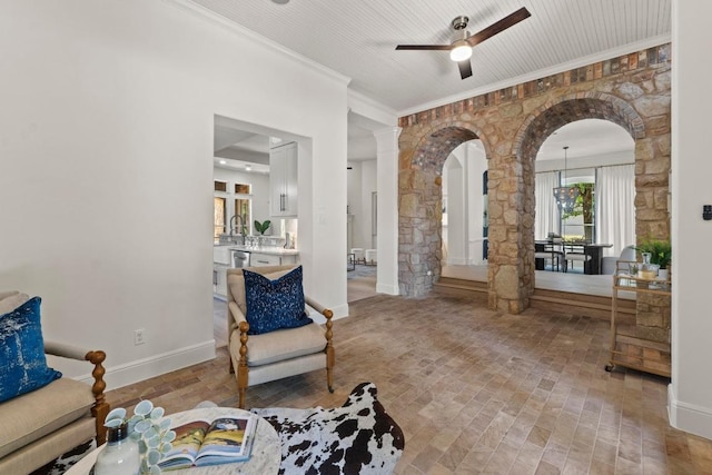 908 Lakewood Hills Ter, Austin, TX 78732 - living area featuring arched walkways, ceiling fan, crown molding, and ornate columns