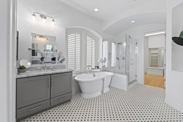 908 Lakewood Hills Ter, Austin, TX 78732 - full bath featuring a stall shower, a soaking tub, vanity, tile patterned floors, and lofted ceiling