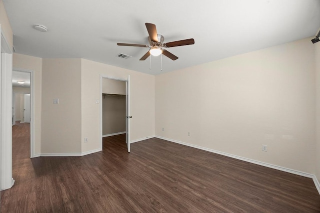 13620 Merseyside Dr, Pflugerville, TX 78660 - unfurnished bedroom with dark wood-type flooring, a walk in closet, and ceiling fan