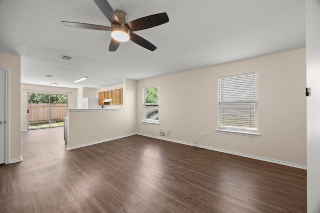 13620 Merseyside Dr, Pflugerville, TX 78660 - unfurnished living room featuring dark wood-type flooring and a ceiling fan