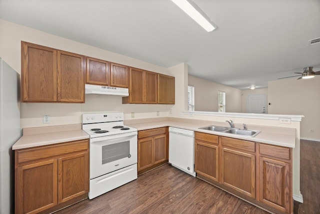 13620 Merseyside Dr, Pflugerville, TX 78660 - kitchen with white appliances, under cabinet range hood, a peninsula, and brown cabinetry