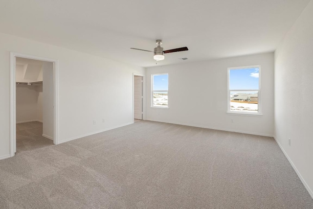 4852 Mozzafiato Ln, Round Rock, TX 78665 - unfurnished bedroom featuring light colored carpet, a spacious closet, and a ceiling fan