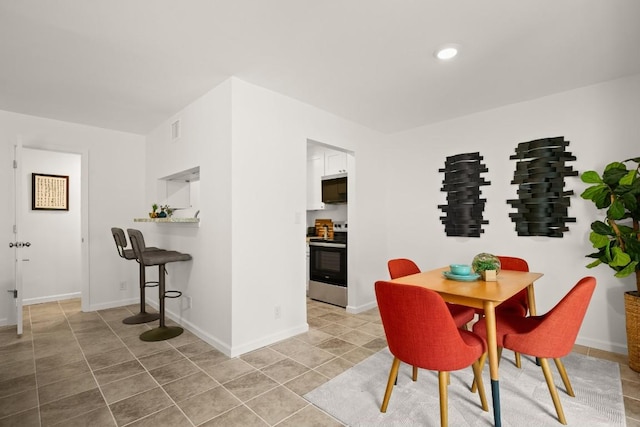 6718 Silvermine Dr Unit 802, Austin, TX 78736 - dining area featuring light tile patterned flooring and baseboards