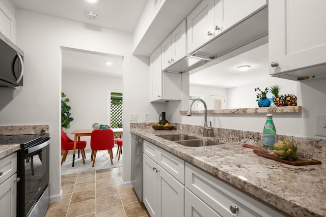 6718 Silvermine Dr Unit 802, Austin, TX 78736 - kitchen featuring appliances with stainless steel finishes, white cabinetry, light stone counters, recessed lighting, and light tile patterned floors