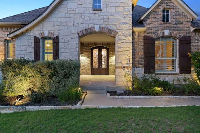 128 Big Sky Cv, Austin, TX 78737 - property entrance featuring roof with shingles, brick siding, and stone siding