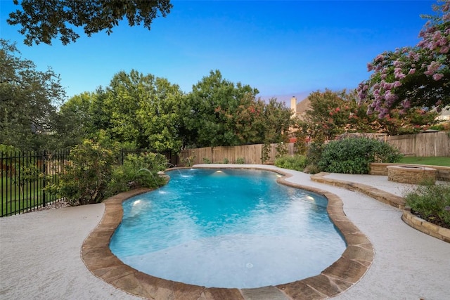 128 Big Sky Cv, Austin, TX 78737 - pool at dusk with a fenced backyard and a patio
