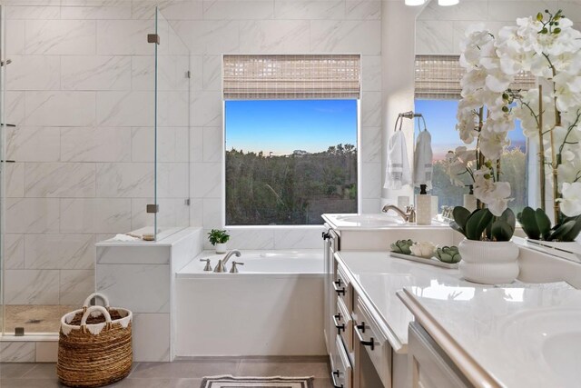 128 Big Sky Cv, Austin, TX 78737 - bathroom featuring double vanity, a garden tub, a tile shower, and tile patterned flooring