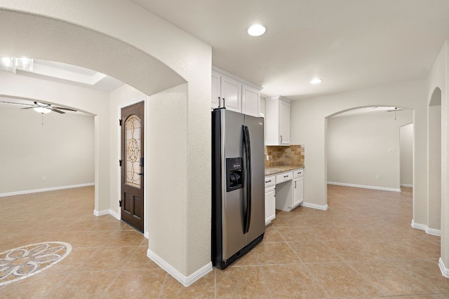 3608 Rockefeller Cv, Lago Vista, TX 78645 - kitchen with stainless steel refrigerator with ice dispenser, a ceiling fan, arched walkways, light tile patterned floors, and recessed lighting