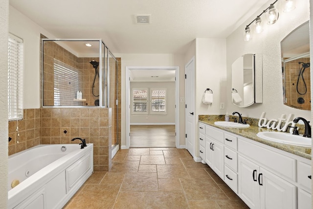 3608 Rockefeller Cv, Lago Vista, TX 78645 - full bathroom with a stall shower, double vanity, a jetted tub, and stone tile flooring