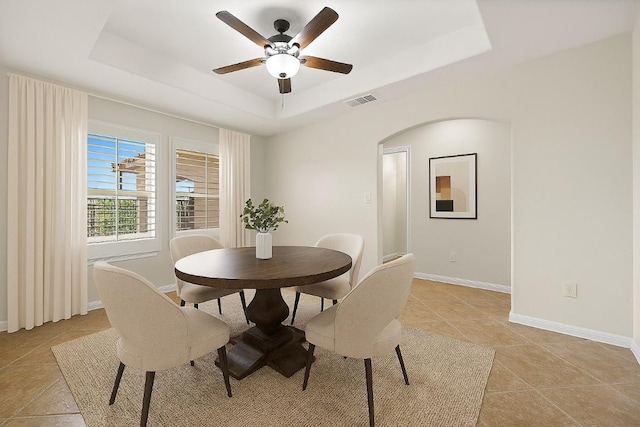 3608 Rockefeller Cv, Lago Vista, TX 78645 - dining room with a raised ceiling, a ceiling fan, arched walkways, and light tile patterned floors
