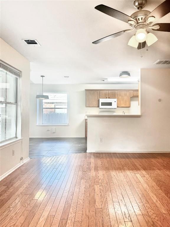 2306 Wilma Rudolph Rd, Austin, TX 78748 - unfurnished living room featuring wood-type flooring and a ceiling fan