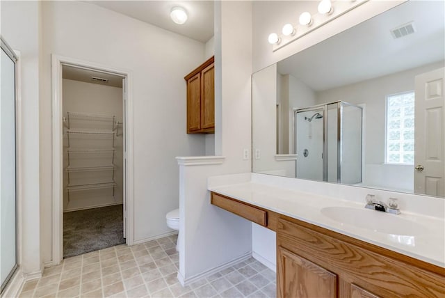 2306 Wilma Rudolph Rd, Austin, TX 78748 - bathroom with a shower stall, a spacious closet, and vanity