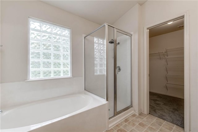2306 Wilma Rudolph Rd, Austin, TX 78748 - bathroom featuring a stall shower, a bath, healthy amount of natural light, and a walk in closet