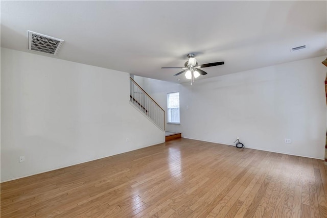 2306 Wilma Rudolph Rd, Austin, TX 78748 - unfurnished living room with ceiling fan, stairs, and light wood-type flooring