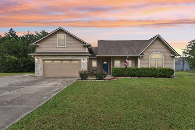 157 Old Firetower Rd, Bastrop, TX 78602 - view of front facade with concrete driveway, a garage, a front lawn, and stone siding