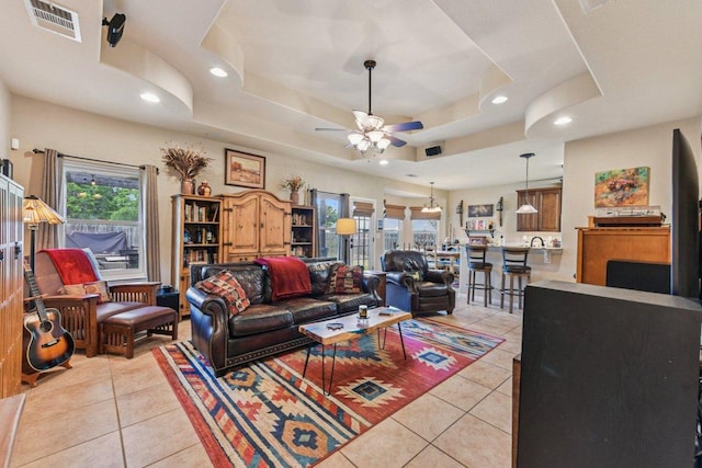 157 Old Firetower Rd, Bastrop, TX 78602 - living room featuring light tile patterned flooring, ceiling fan, recessed lighting, and a tray ceiling