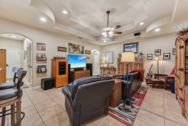 157 Old Firetower Rd, Bastrop, TX 78602 - living room featuring arched walkways, a raised ceiling, light tile patterned flooring, and recessed lighting