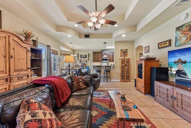 157 Old Firetower Rd, Bastrop, TX 78602 - living area with a raised ceiling, ceiling fan, light tile patterned floors, arched walkways, and recessed lighting