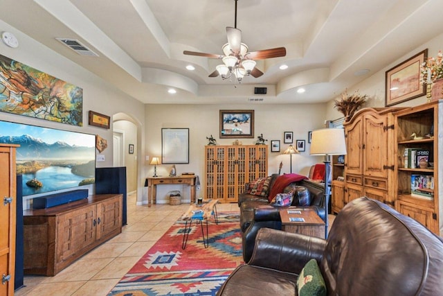 157 Old Firetower Rd, Bastrop, TX 78602 - living room featuring a tray ceiling, a ceiling fan, light tile patterned floors, arched walkways, and recessed lighting