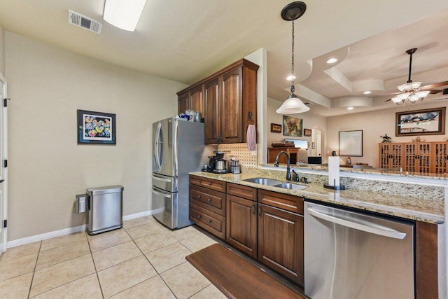 157 Old Firetower Rd, Bastrop, TX 78602 - kitchen with stainless steel appliances, ceiling fan, light stone counters, light tile patterned floors, and hanging light fixtures