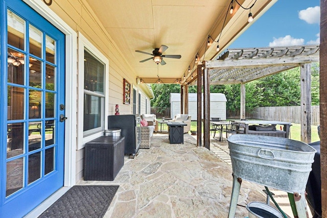 157 Old Firetower Rd, Bastrop, TX 78602 - view of patio featuring a shed, a fire pit, outdoor dining space, and ceiling fan