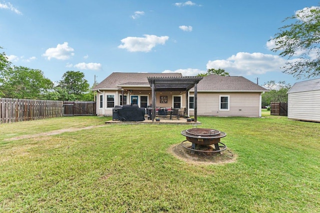 157 Old Firetower Rd, Bastrop, TX 78602 - back of property with a fire pit, a pergola, a fenced backyard, and a patio