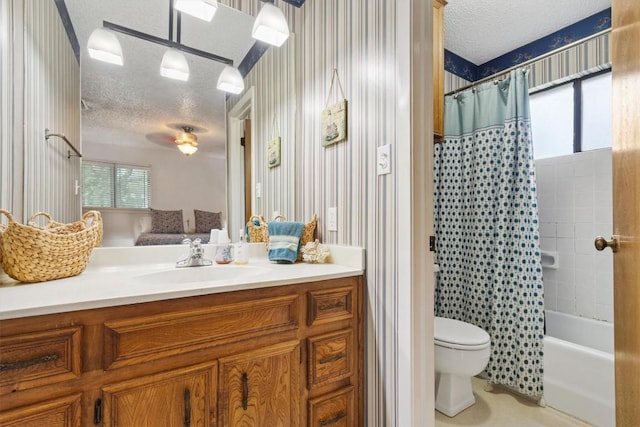 4001 Granada Dr, Georgetown, TX 78628 - bathroom featuring a textured ceiling, vanity, shower / bath combo with shower curtain, a ceiling fan, and wallpapered walls