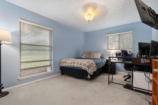 4001 Granada Dr, Georgetown, TX 78628 - carpeted bedroom featuring a desk, multiple windows, and a textured ceiling