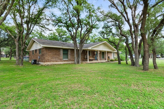 4001 Granada Dr, Georgetown, TX 78628 - ranch-style home with brick siding, a front lawn, and a porch