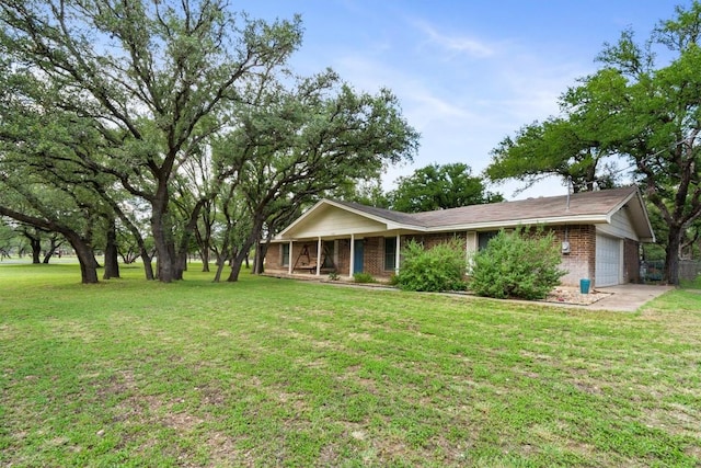 4001 Granada Dr, Georgetown, TX 78628 - single story home with an attached garage, a front yard, brick siding, and a porch
