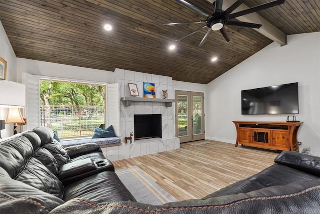 4001 Granada Dr, Georgetown, TX 78628 - living room with ceiling fan, a wood ceiling with exposed beams, healthy amount of natural light, wood finished floors, and a fireplace