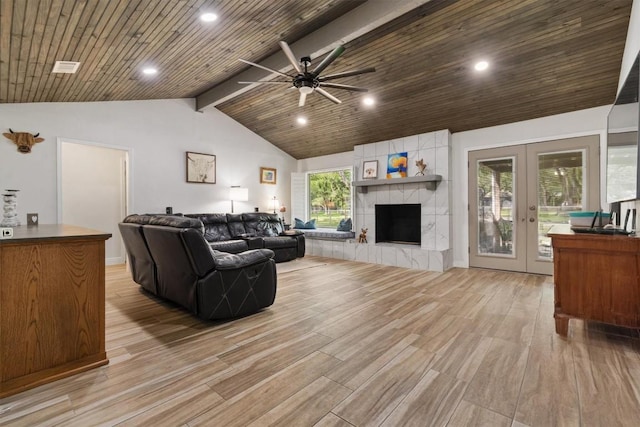 4001 Granada Dr, Georgetown, TX 78628 - living room with light wood-type flooring, a ceiling fan, french doors, recessed lighting, and a tiled fireplace