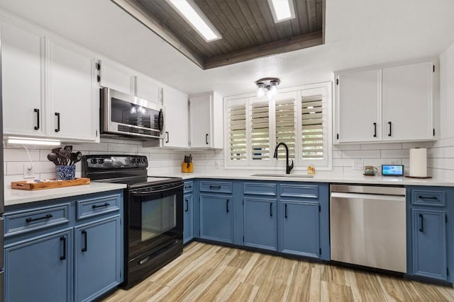 4001 Granada Dr, Georgetown, TX 78628 - kitchen with appliances with stainless steel finishes, blue cabinets, light countertops, and wooden ceiling