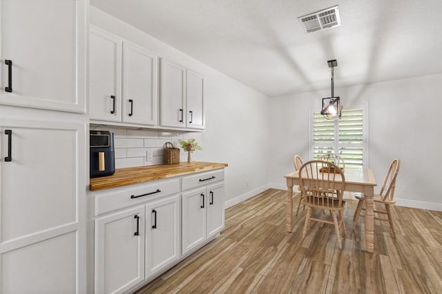 4001 Granada Dr, Georgetown, TX 78628 - dining space featuring baseboards and light wood-style floors