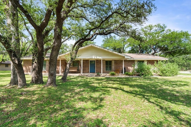 4001 Granada Dr, Georgetown, TX 78628 - ranch-style home featuring brick siding, a front lawn, and a porch