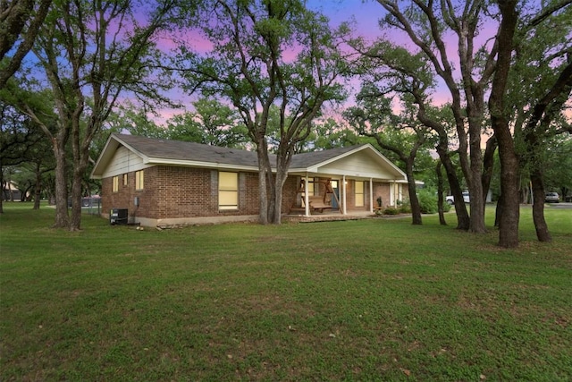 4001 Granada Dr, Georgetown, TX 78628 - view of front of home with brick siding, a front lawn, and a porch