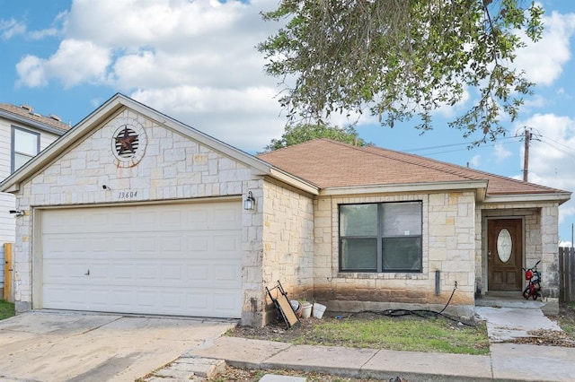 13604 Gilwell Dr, Del Valle, TX 78617 - ranch-style house with stone siding, an attached garage, concrete driveway, and a shingled roof