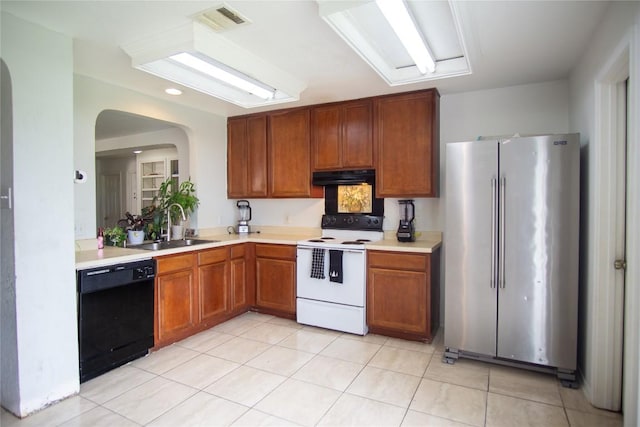 13604 Gilwell Dr, Del Valle, TX 78617 - kitchen featuring freestanding refrigerator, white range with electric cooktop, black dishwasher, under cabinet range hood, and light countertops
