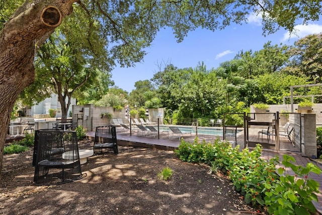 3100 Menchaca Rd Unit 24, Austin, TX 78704 - view of property's community with a swimming pool, a deck, and view of scattered trees