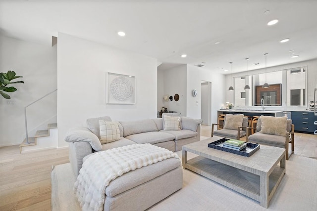 3100 Menchaca Rd Unit 24, Austin, TX 78704 - living room featuring light wood-style floors, recessed lighting, and stairs