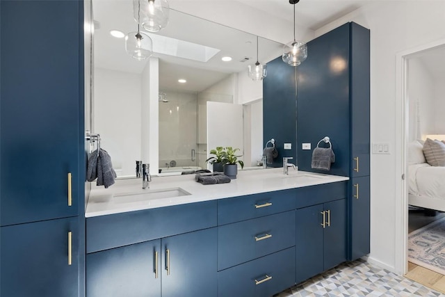 3100 Menchaca Rd Unit 24, Austin, TX 78704 - bathroom featuring a skylight, double vanity, ensuite bathroom, a shower with door, and recessed lighting