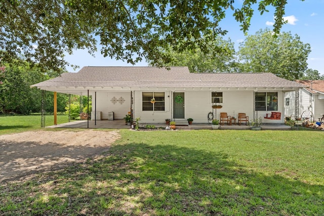 1215 Bois Darc St, Lockhart, TX 78644 - ranch-style home featuring a front yard, a patio area, roof with shingles, and dirt driveway