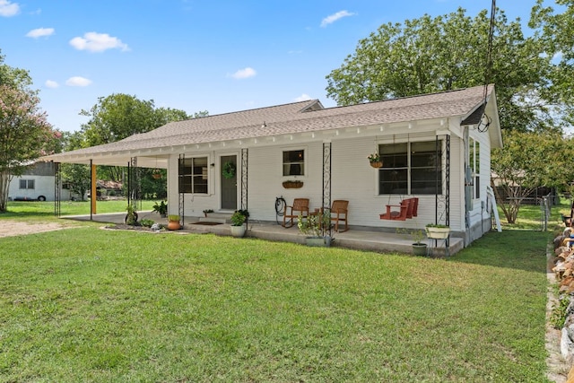 1215 Bois Darc St, Lockhart, TX 78644 - view of front facade with covered porch and a shingled roof