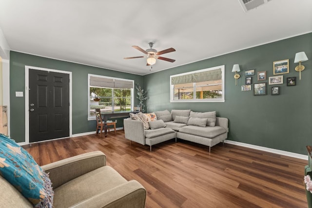 1215 Bois Darc St, Lockhart, TX 78644 - living room featuring a ceiling fan, wood finished floors, and ornamental molding
