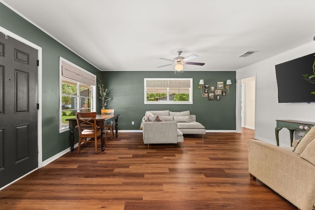 1215 Bois Darc St, Lockhart, TX 78644 - living room featuring healthy amount of natural light, a ceiling fan, wood finished floors, and crown molding