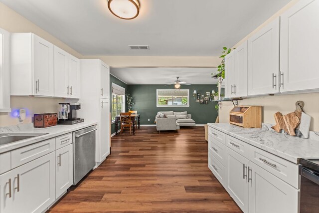 1215 Bois Darc St, Lockhart, TX 78644 - kitchen featuring dishwasher, dark wood-type flooring, white cabinets, light countertops, and a ceiling fan