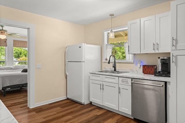 1215 Bois Darc St, Lockhart, TX 78644 - kitchen featuring stainless steel dishwasher, freestanding refrigerator, white cabinetry, dark wood finished floors, and a ceiling fan